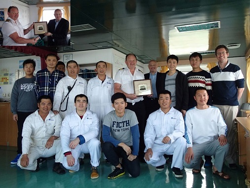 Top corner: Capt Alan Birley and General Manager Paul Oliver Back row: OS Zhan Liuhan, 3/E Liu Xiaofei , J/O Zhou Jin, G/E Pu Wenguang, C/E Martin Heard (almost obscured behind Pu Wenguang), Bosun Wang Jiedong, Captain Alan Birley, General Manager Paul Oliver, 3/E Jiao Zebing, Oiler Guan Wei, 2/E Julian Edwardes Front row: 3/E (Asst. G/E) Luan Yunxiu, Steward Wang Bei , Deck Cadet Yu Wenjie, Deck Cadet Sun Zongzong, 3/O Zhang Wentao